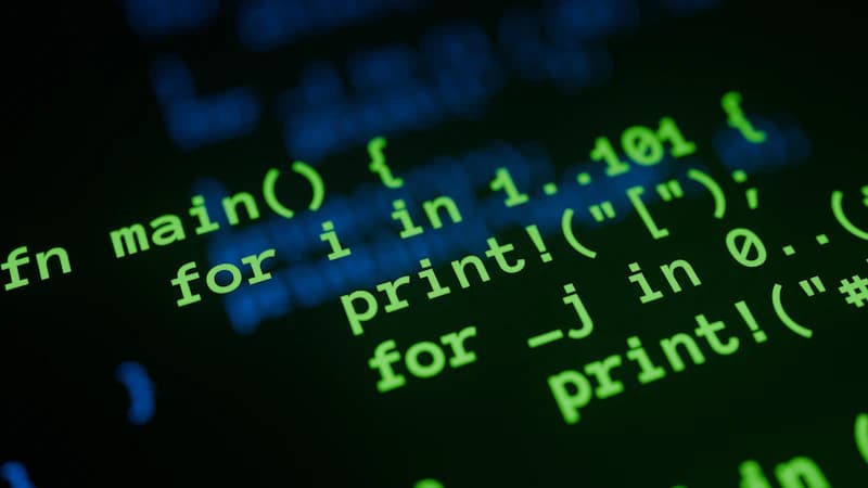 Source code glowing green on a dark screen